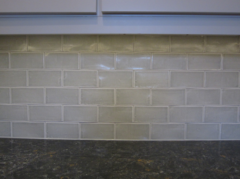 Inspiration for a mid-sized transitional l-shaped light wood floor eat-in kitchen remodel in Chicago with gray backsplash, subway tile backsplash, an undermount sink, shaker cabinets, white cabinets, granite countertops, stainless steel appliances and no island