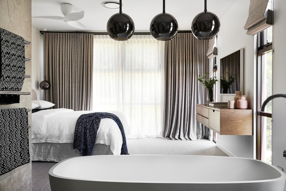 Inspiration for a large contemporary master bedroom in Sydney with white walls, carpet and grey floor.