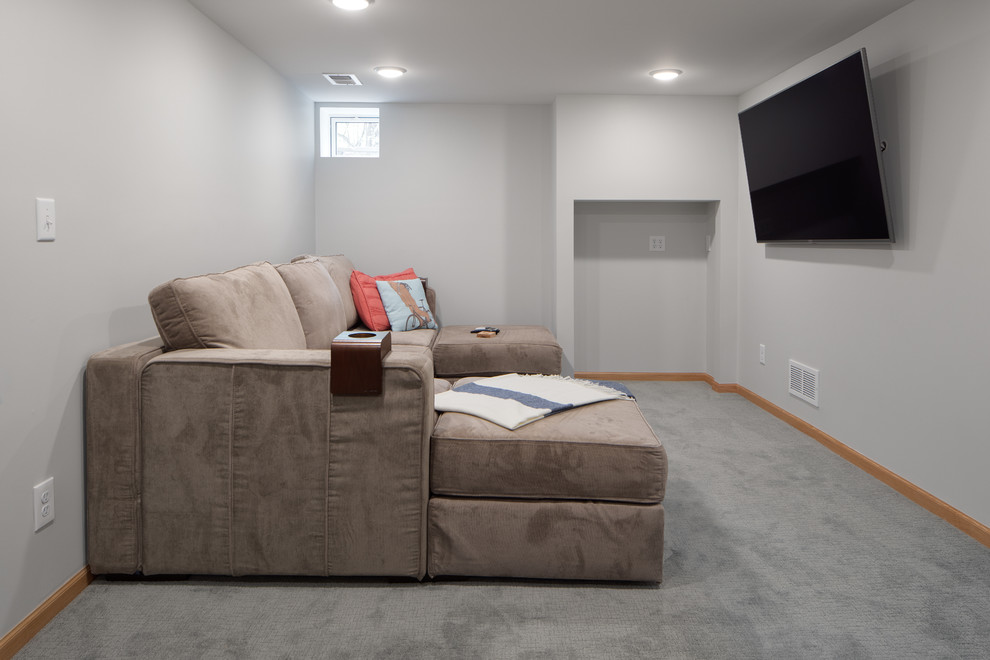 Design ideas for a mid-sized transitional walk-out basement in Minneapolis with grey walls, carpet, no fireplace and grey floor.