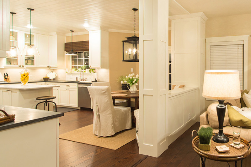 Eat-in kitchen - transitional u-shaped eat-in kitchen idea in Austin with shaker cabinets, white cabinets, stainless steel appliances, beige walls and an island