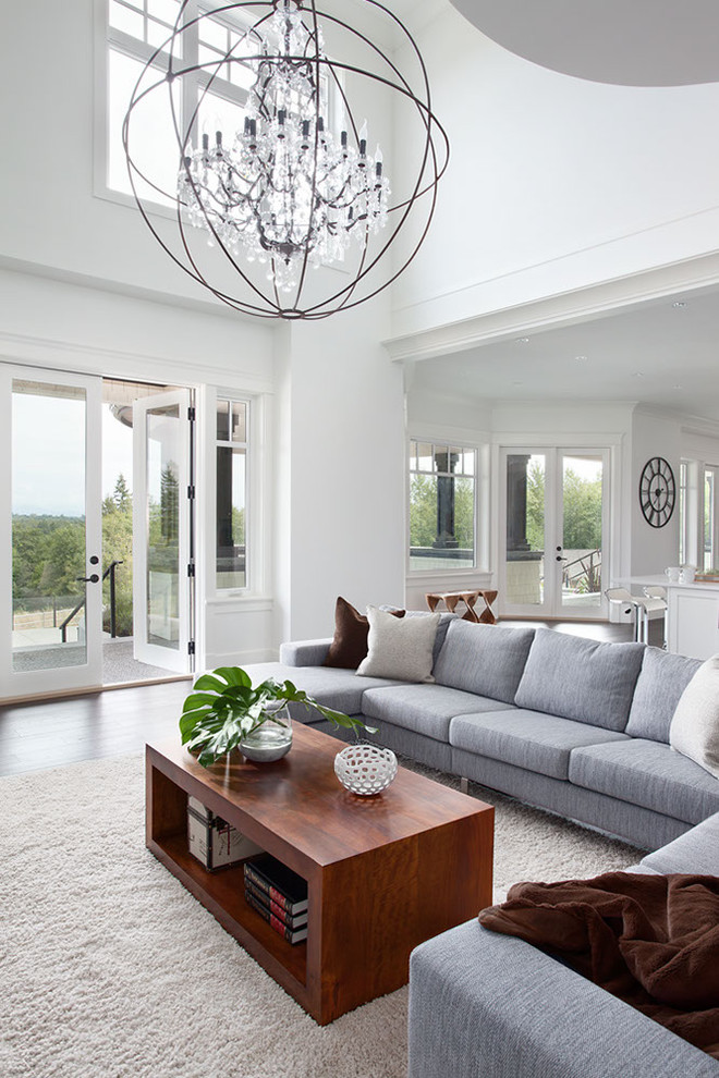 Contemporary open concept living room in Vancouver with white walls.