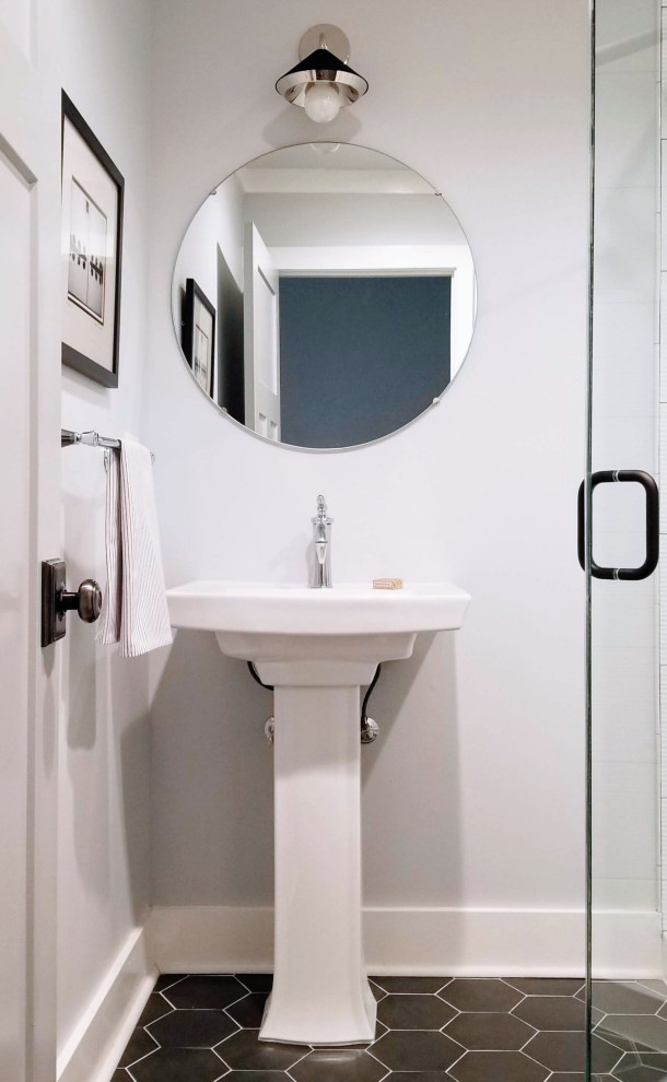 Photo of a small contemporary bathroom in Atlanta with white cabinets, a corner shower, a two-piece toilet, white walls, porcelain flooring, a pedestal sink, black floors, a hinged door, a single sink and a freestanding vanity unit.