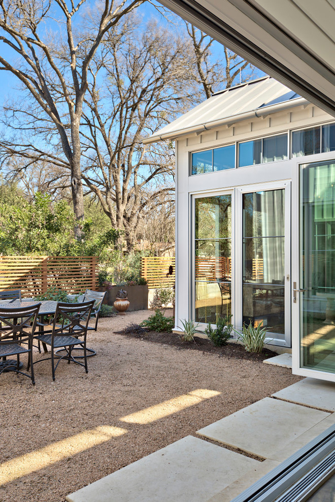 This is an example of a large transitional front yard patio in Austin with no cover and decomposed granite.