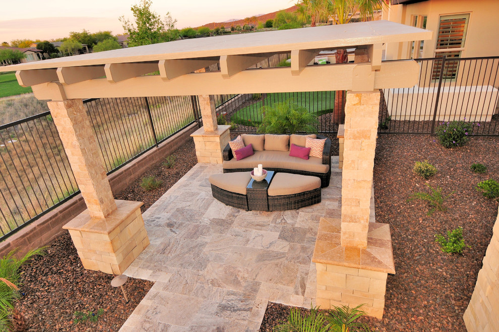 Mid-sized backyard patio in Phoenix with a pergola and natural stone pavers.