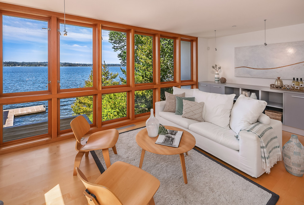 Beach style living room in Seattle with orange floor, white walls and medium hardwood floors.