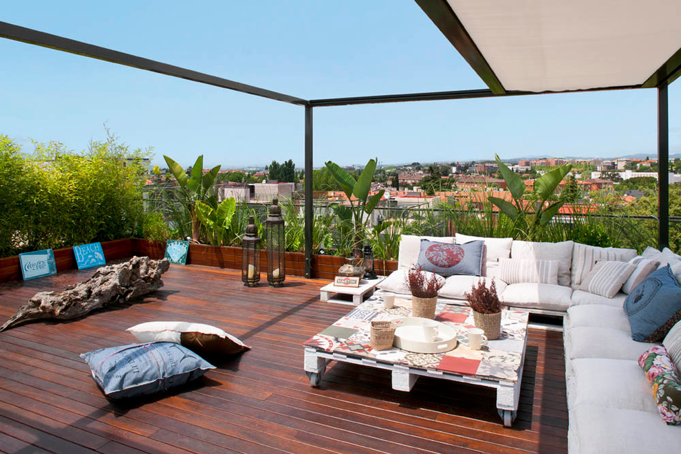 Design ideas for a large contemporary rooftop and rooftop deck in Barcelona with a container garden and an awning.