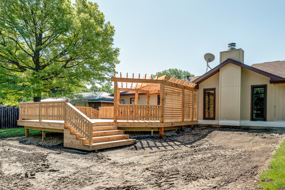 Inspiration for a large transitional backyard deck remodel in Chicago with a pergola