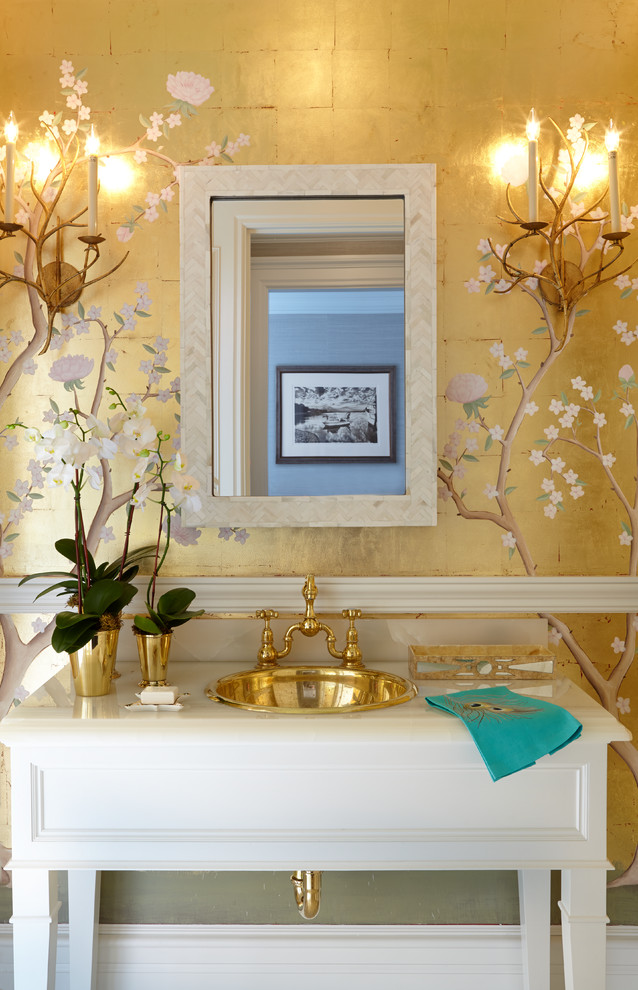 Inspiration for a mid-sized eclectic powder room in New York with furniture-like cabinets, a drop-in sink, onyx benchtops, white cabinets and yellow walls.