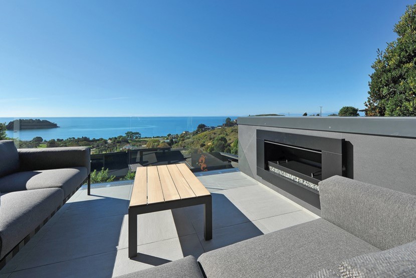 Photo of a large beach style side yard deck in Other with a fire feature and no cover.