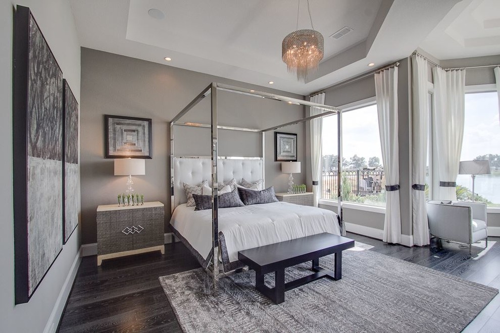 This is an example of a transitional bedroom in Houston with grey walls and dark hardwood floors.