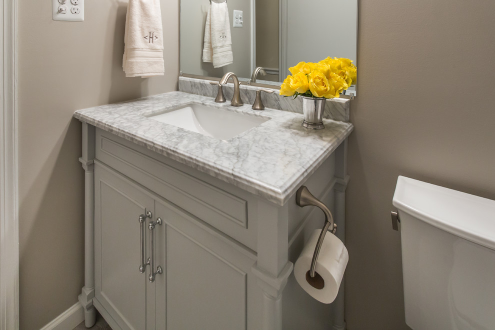 Inspiration for a small transitional kids bathroom in DC Metro with furniture-like cabinets, grey cabinets, an alcove tub, a shower/bathtub combo, a one-piece toilet, gray tile, beige walls, porcelain floors, an undermount sink, engineered quartz benchtops and porcelain tile.