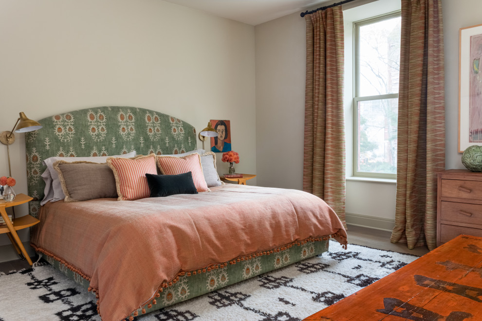 Photo of an eclectic bedroom in New York with beige walls, medium hardwood floors and brown floor.