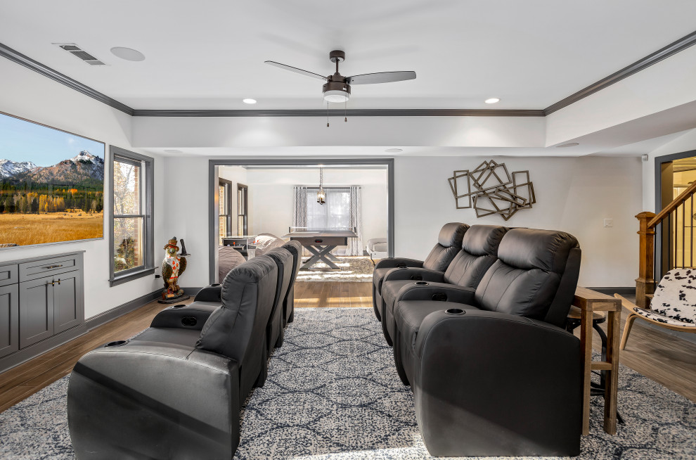 Design ideas for a large transitional open concept home theatre in Atlanta with white walls, porcelain floors, a wall-mounted tv and brown floor.
