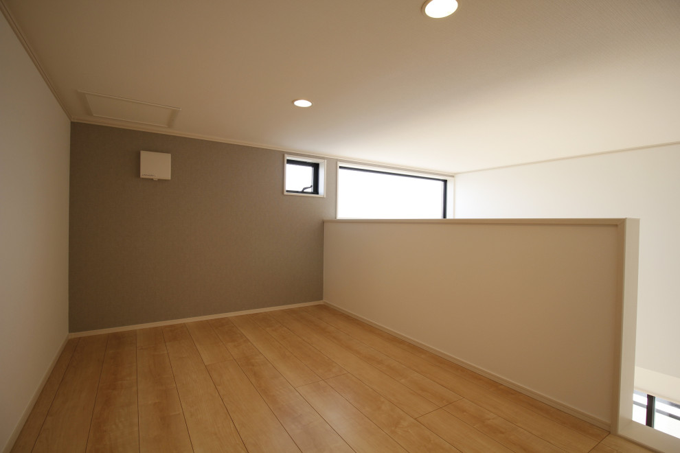 Photo of a mid-sized country master bedroom in Other with grey walls, plywood floors, beige floor, wallpaper and wallpaper.