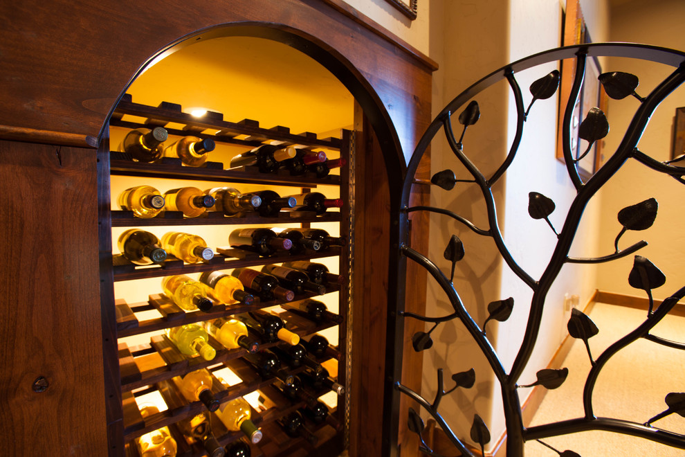 Inspiration for a small country wine cellar in Denver with storage racks, ceramic floors and beige floor.