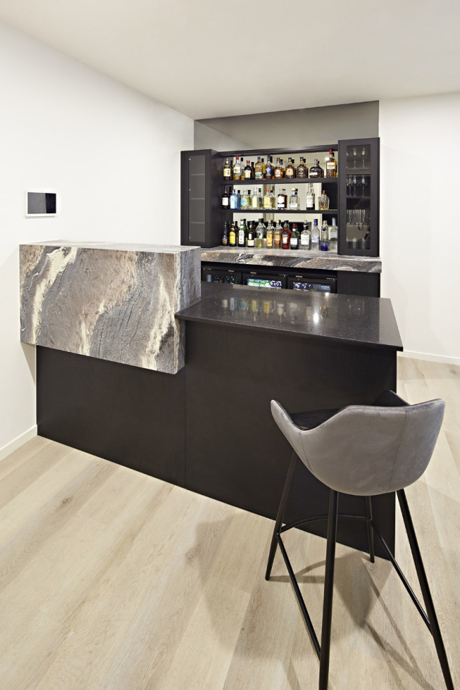This is an example of a mid-sized contemporary u-shaped seated home bar in Melbourne with marble benchtops, mirror splashback and multi-coloured benchtop.