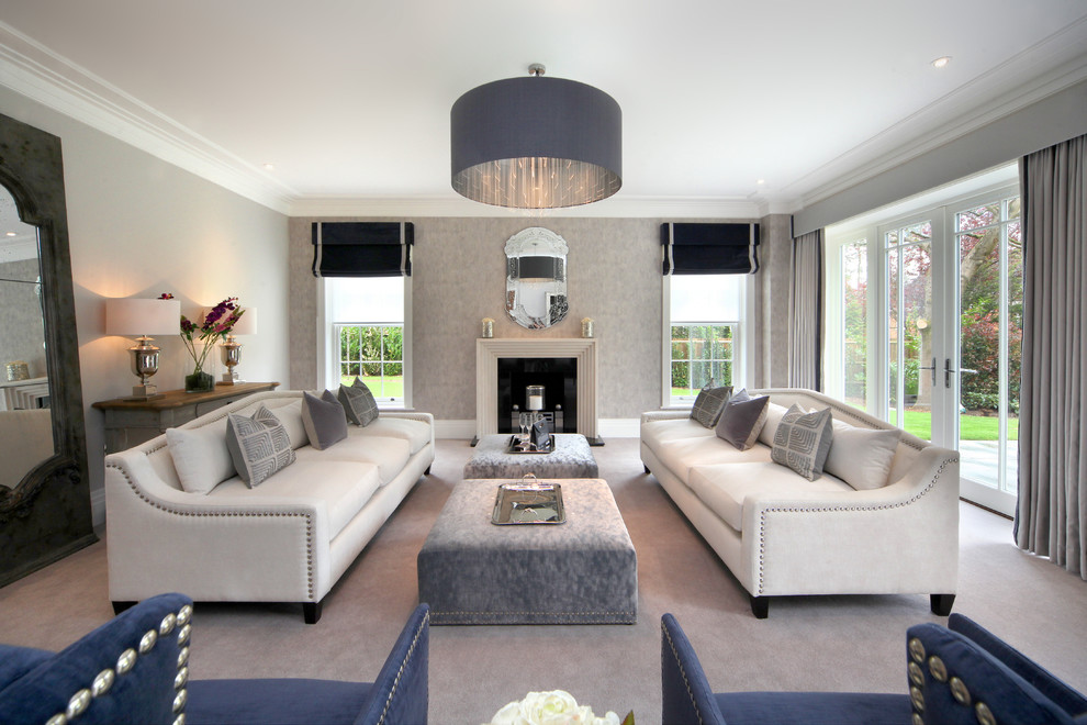Photo of a transitional living room in Buckinghamshire with grey walls, carpet, a standard fireplace and grey floor.