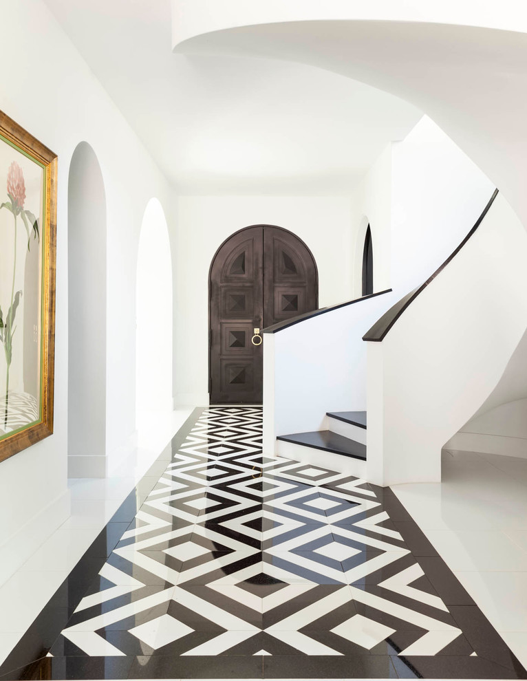 Photo of a mediterranean entry hall in Dallas with white walls, marble floors, a double front door, a dark wood front door and multi-coloured floor.