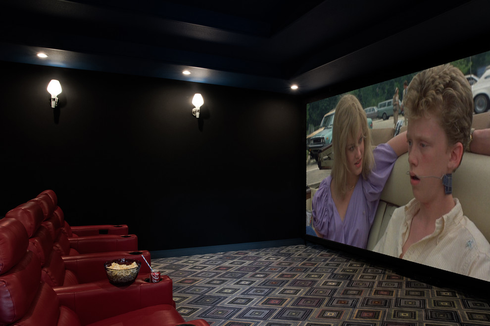 Photo of a mid-sized eclectic enclosed home theatre in Austin with blue walls, carpet and a built-in media wall.