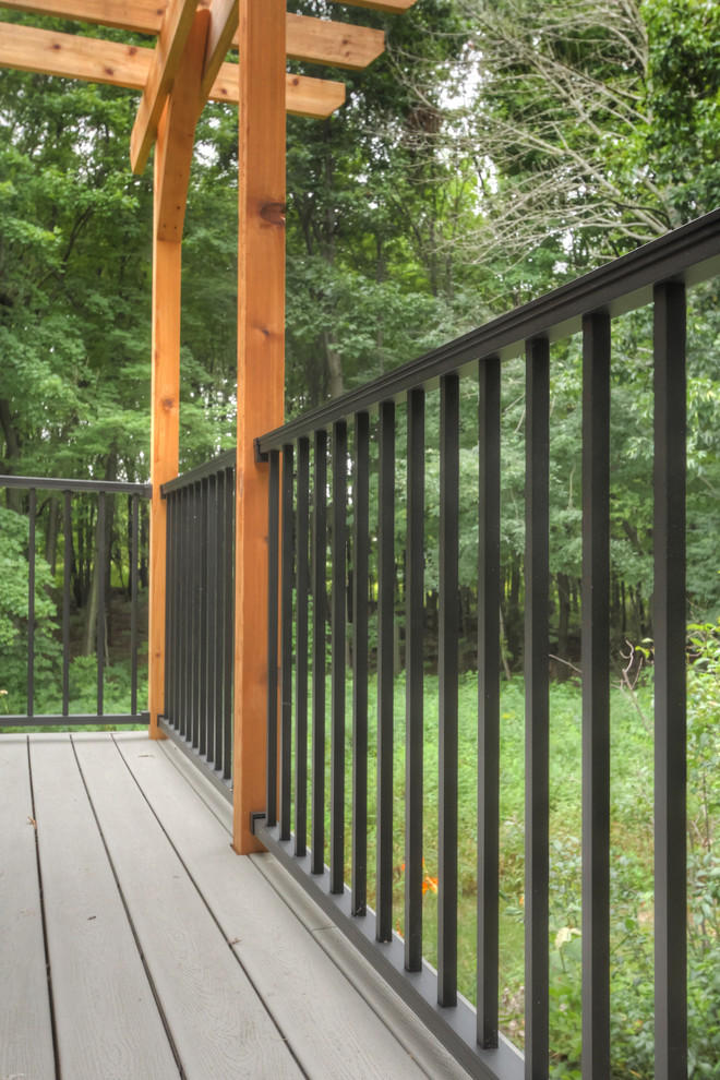 Inspiration for a small country backyard deck in Grand Rapids with a pergola.