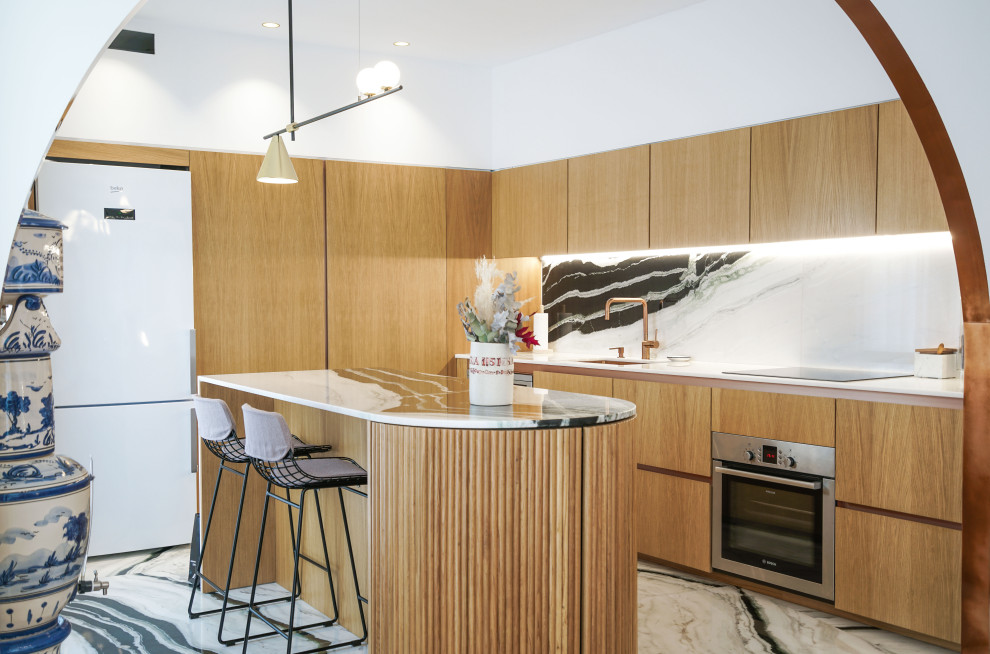 Photo of a contemporary l-shaped open plan kitchen in Alicante-Costa Blanca with a submerged sink, flat-panel cabinets, medium wood cabinets, marble worktops, white splashback, stone slab splashback, marble flooring, an island and white worktops.