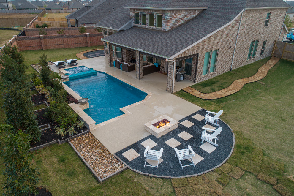 Design ideas for a large arts and crafts backyard rectangular pool in Houston with a hot tub and decking.