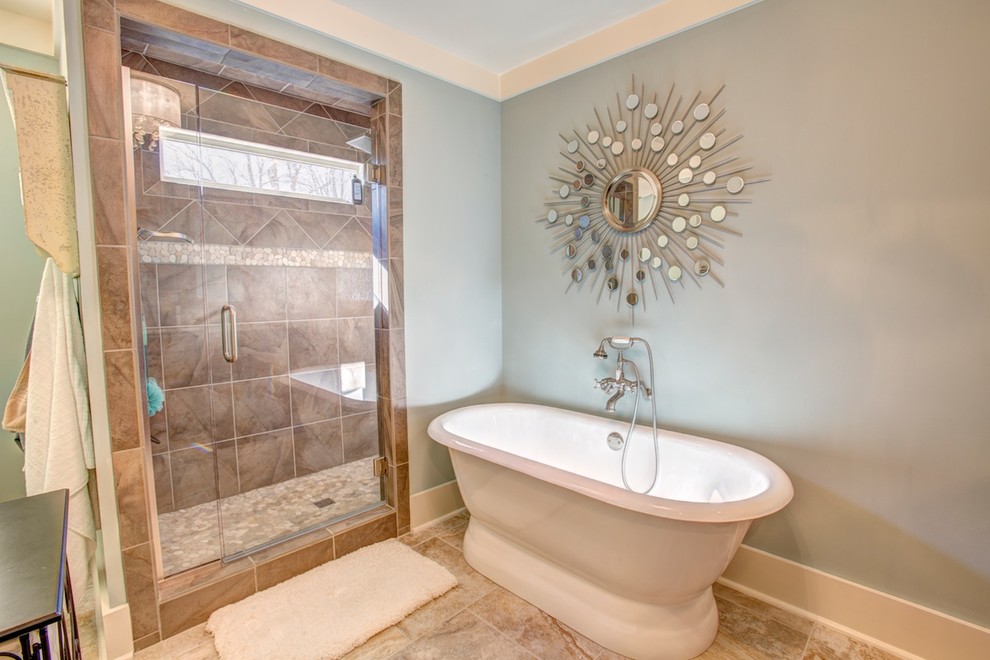 Mid-sized elegant ceramic tile bathroom photo in Birmingham with an undermount sink, raised-panel cabinets, brown cabinets, granite countertops and blue walls