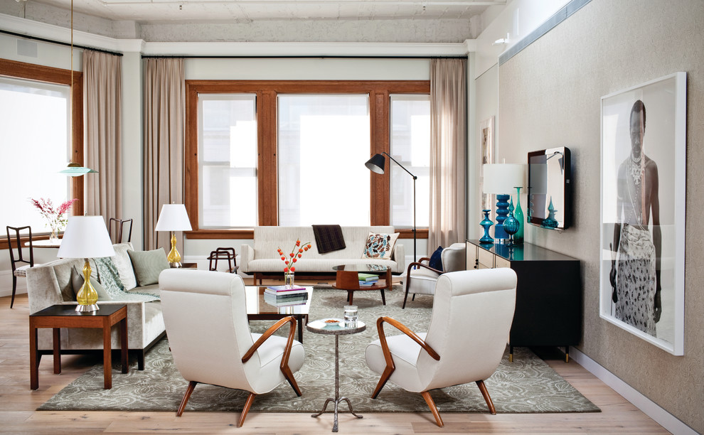 This is an example of a large midcentury living room in New York with beige walls, no fireplace and a wall-mounted tv.
