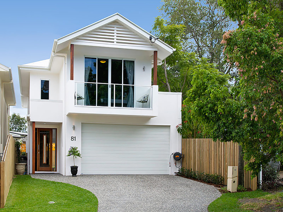 Photo of a mid-sized contemporary two-storey white house exterior in Brisbane with mixed siding, a gable roof and a metal roof.
