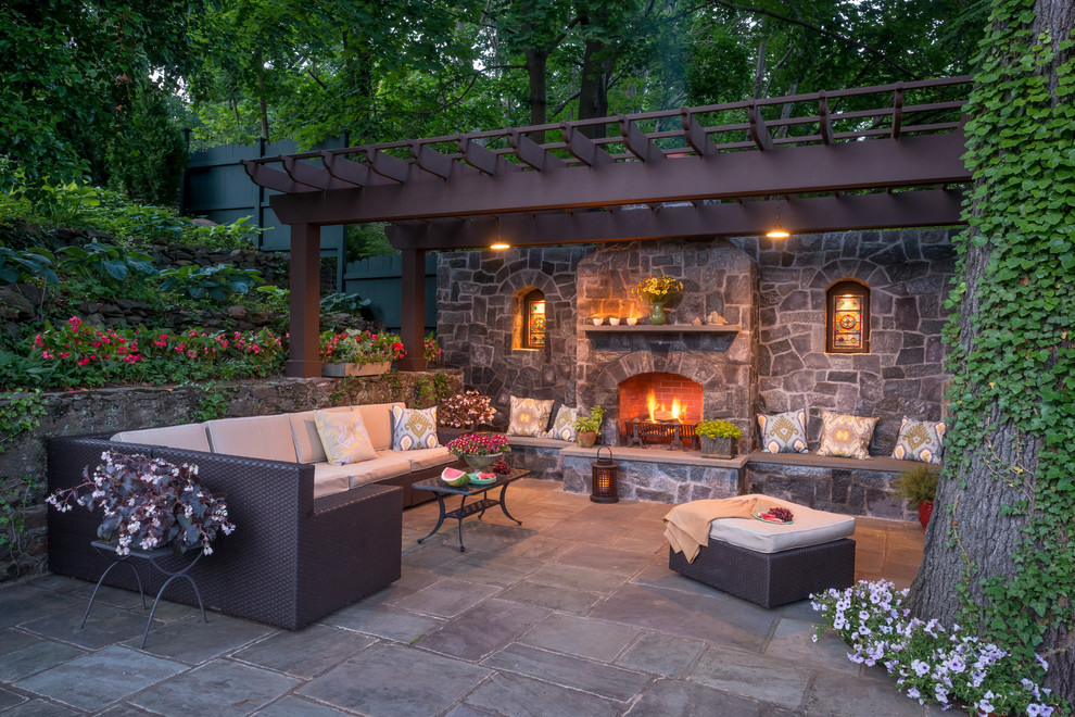 Inspiration for an expansive traditional patio in New York with a fire feature.