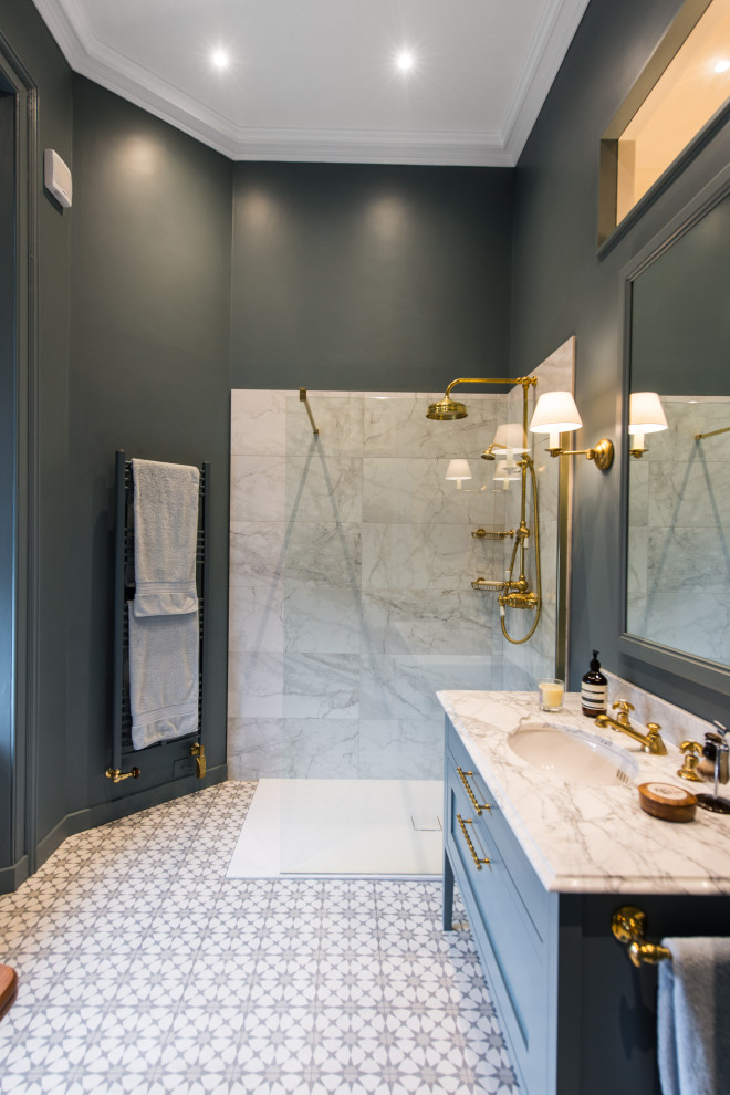 Large transitional master bathroom in Edinburgh with shaker cabinets, blue cabinets, an open shower, gray tile, black walls, an undermount sink, multi-coloured floor, an open shower, grey benchtops, a single vanity and a built-in vanity.