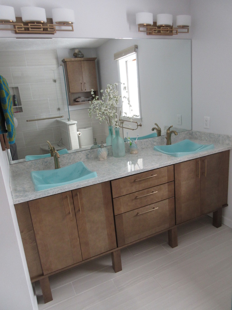 Mid-sized transitional master beige tile and porcelain tile porcelain tile double shower photo with flat-panel cabinets, medium tone wood cabinets, a two-piece toilet, gray walls, a vessel sink and quartz countertops