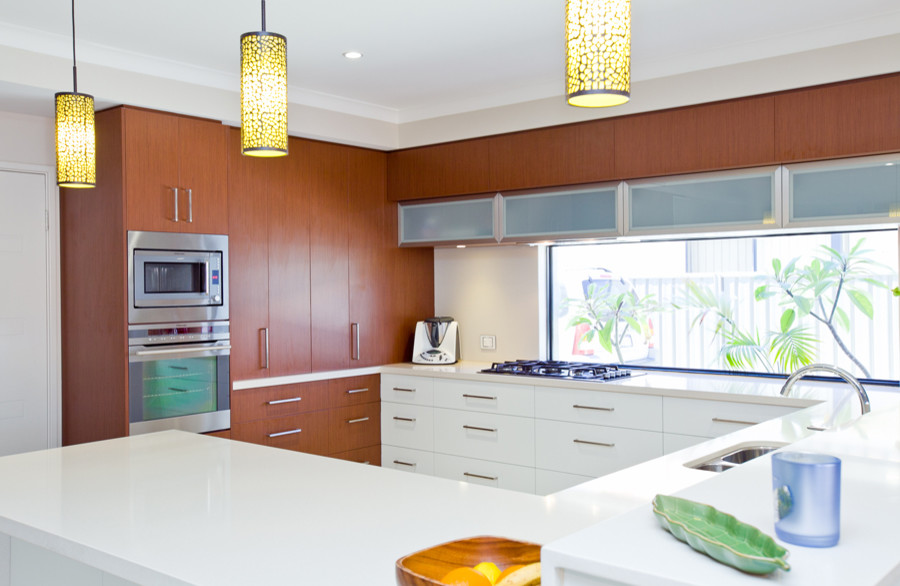 Design ideas for a large modern u-shaped open plan kitchen in Perth with an undermount sink, flat-panel cabinets, white cabinets, quartz benchtops, stainless steel appliances, porcelain floors and a peninsula.