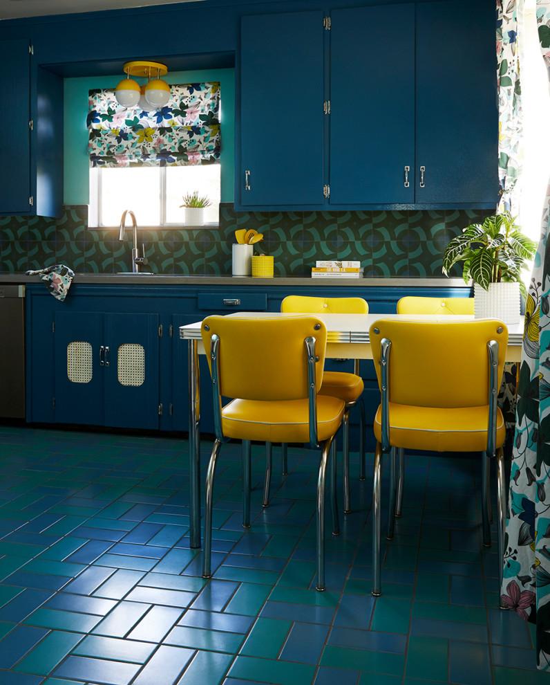 This is an example of a mid-sized midcentury u-shaped kitchen in San Francisco with an undermount sink, flat-panel cabinets, blue cabinets, quartz benchtops, blue splashback, cement tile splashback, stainless steel appliances, porcelain floors, no island, blue floor and grey benchtop.