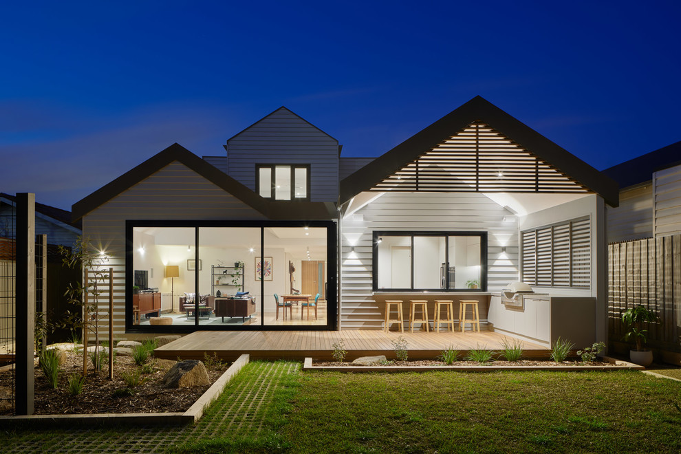 Inspiration for a large contemporary two-storey grey house exterior in Melbourne with concrete fiberboard siding, a gable roof and a metal roof.