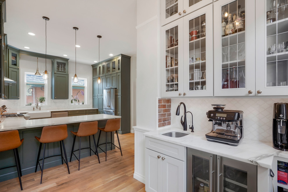Large classic u-shaped kitchen/diner in Denver with a belfast sink, flat-panel cabinets, green cabinets, stainless steel appliances and a breakfast bar.