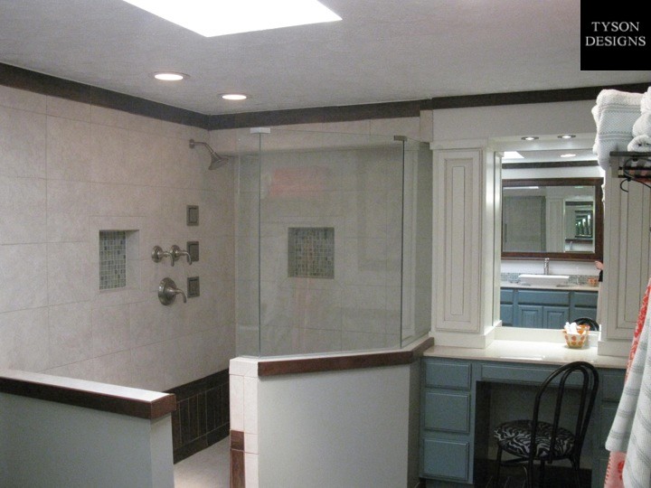Example of a large transitional master brown tile and ceramic tile ceramic tile doorless shower design in Cincinnati with a vessel sink, raised-panel cabinets, turquoise cabinets, solid surface countertops and gray walls