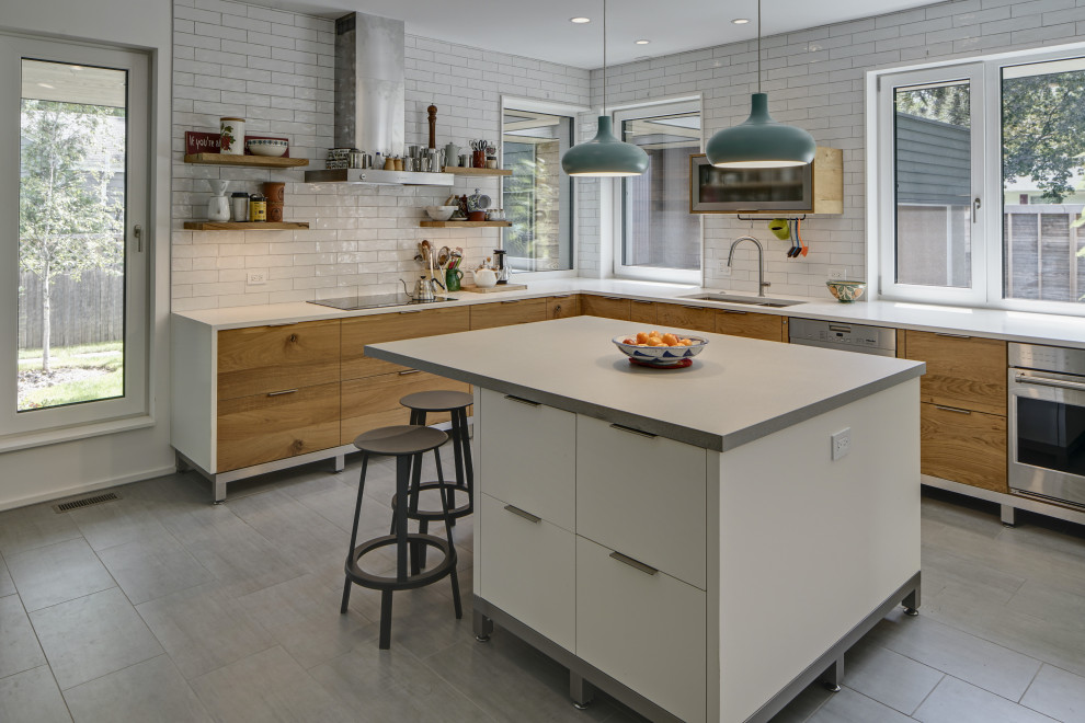 Trendy kitchen photo in Chicago with a drop-in sink, medium tone wood cabinets, white backsplash and an island