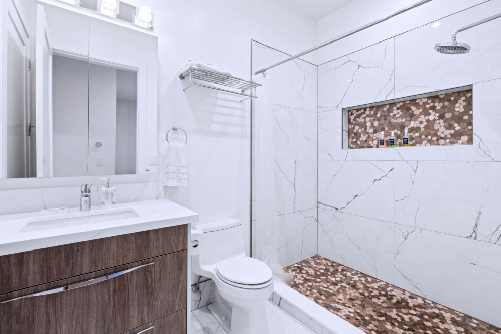 ADU Bathroom with Marble-Look Tub-Shower and Wood Vanity