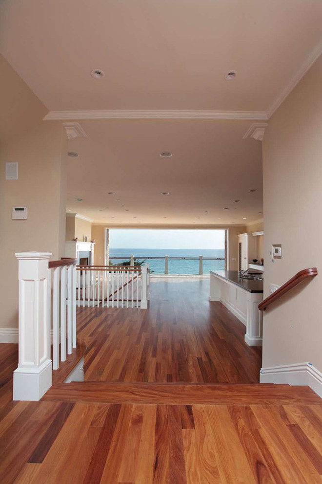 Large beach style foyer in Orange County with beige walls, medium hardwood floors, a double front door and a white front door.