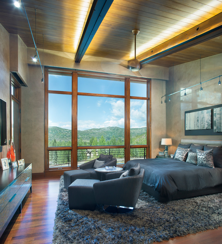 Inspiration for a contemporary bedroom in Denver with grey walls, medium hardwood floors and brown floor.