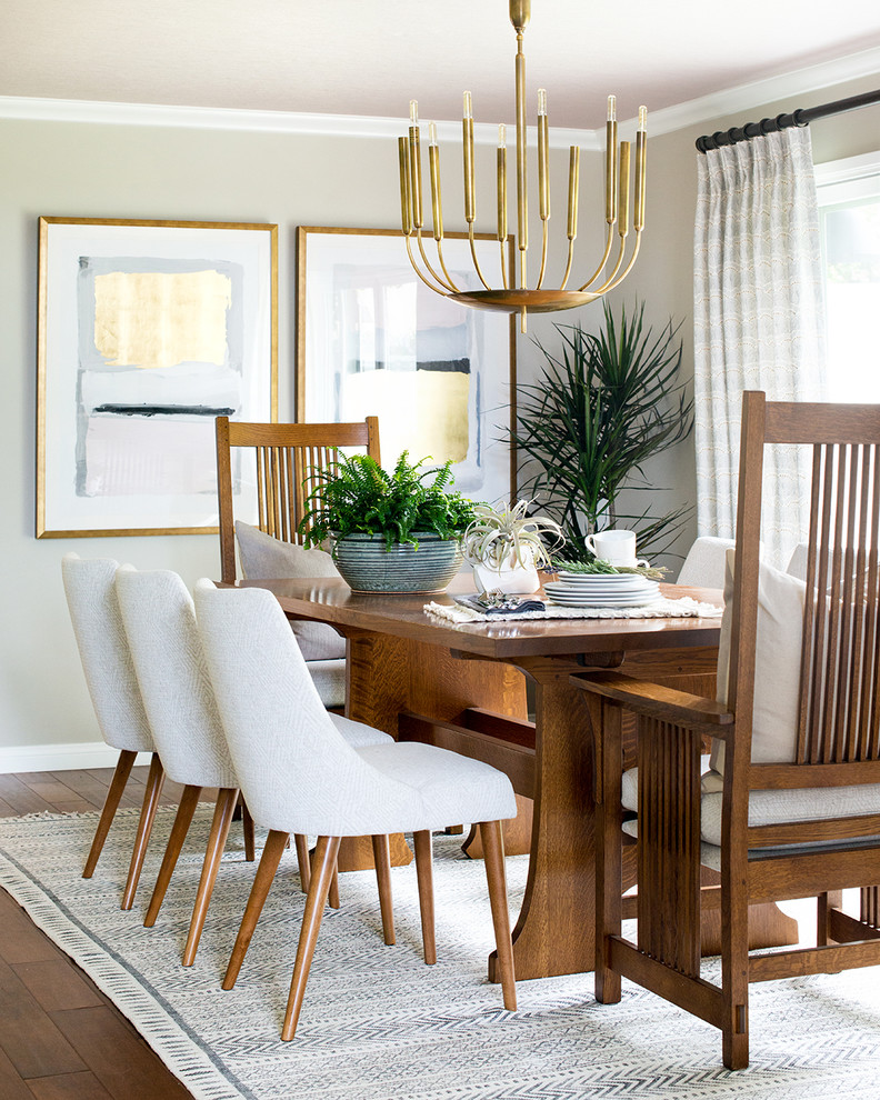 Photo of an eclectic dining room in Los Angeles with beige walls, medium hardwood floors and brown floor.
