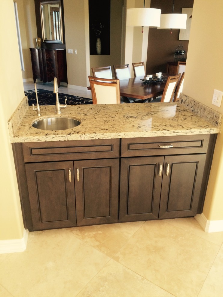 Large transitional l-shaped ceramic tile and beige floor kitchen photo in Phoenix with a double-bowl sink, raised-panel cabinets, dark wood cabinets, granite countertops, multicolored backsplash, stone slab backsplash, stainless steel appliances and an island