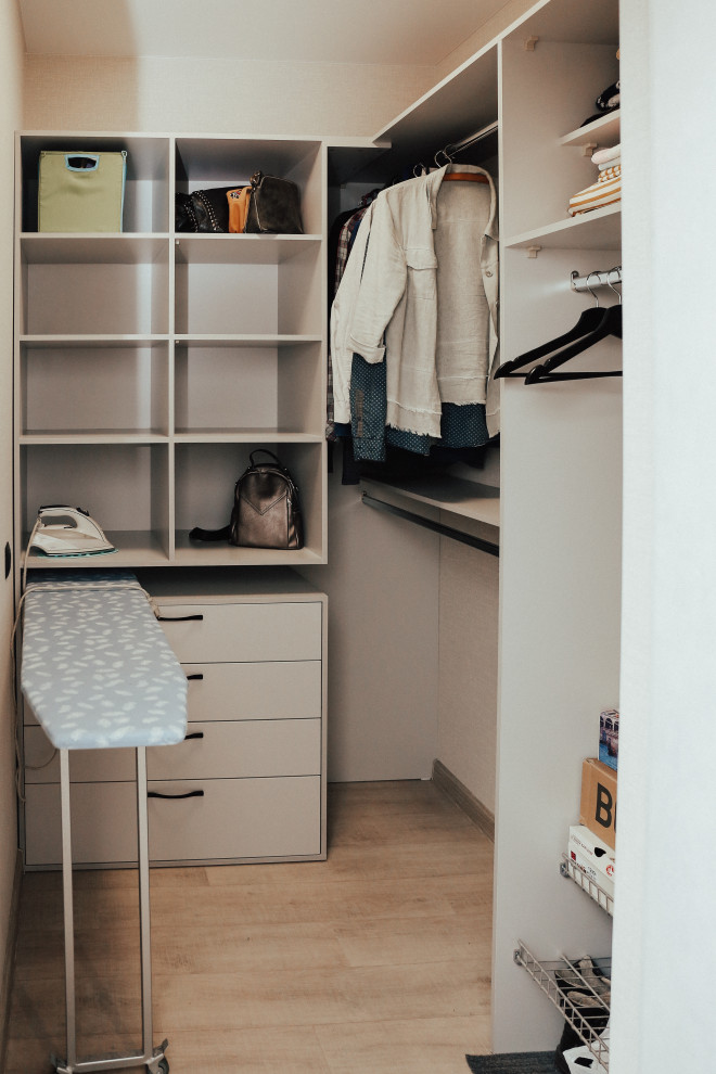 This is an example of a small contemporary storage and wardrobe in Other with laminate floors and grey floor.