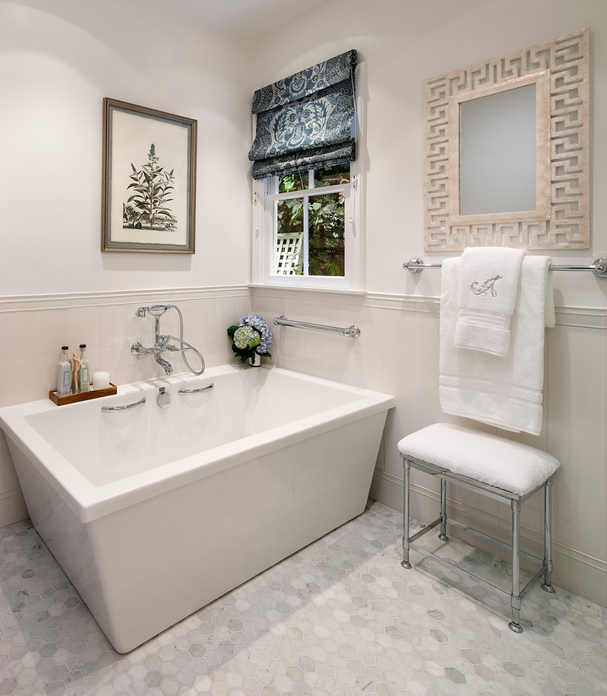 Mid-sized transitional bathroom in Los Angeles with a freestanding tub, white walls, marble floors and grey floor.