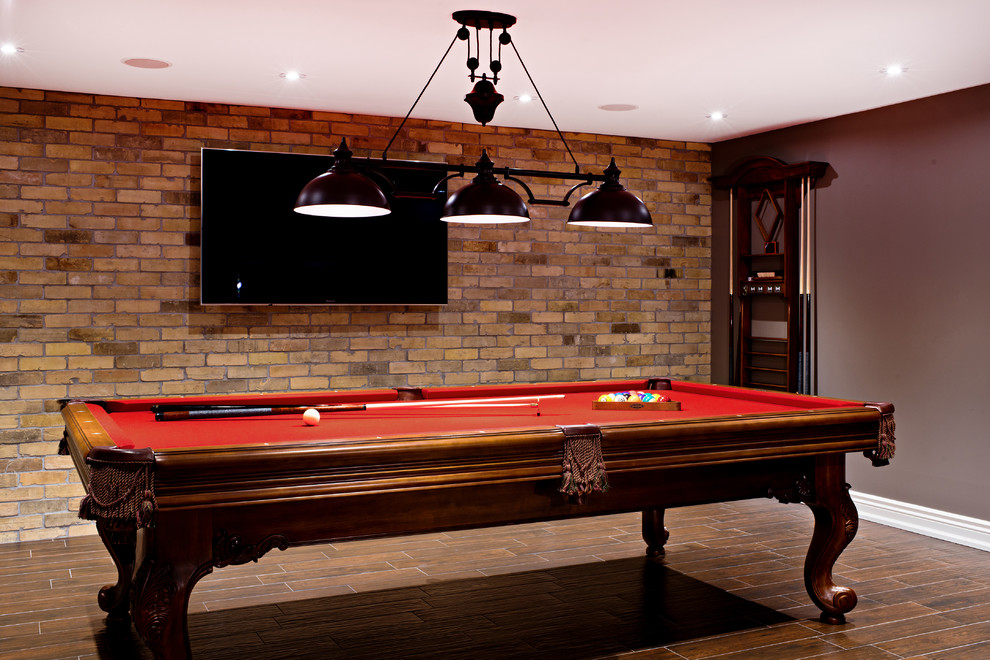 Example of a large transitional underground dark wood floor basement design in Toronto with brown walls and no fireplace