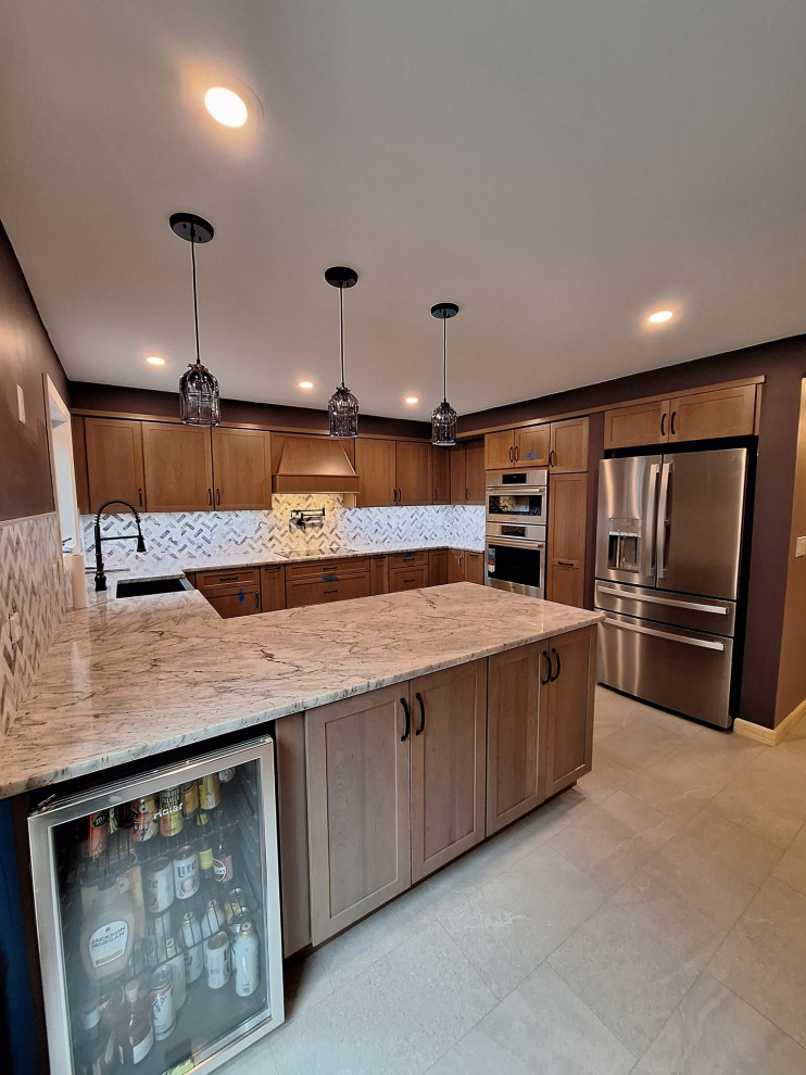 Large transitional u-shaped porcelain tile and gray floor eat-in kitchen photo in Boston with a farmhouse sink, shaker cabinets, medium tone wood cabinets, granite countertops, gray backsplash, marble backsplash, stainless steel appliances, a peninsula and gray countertops