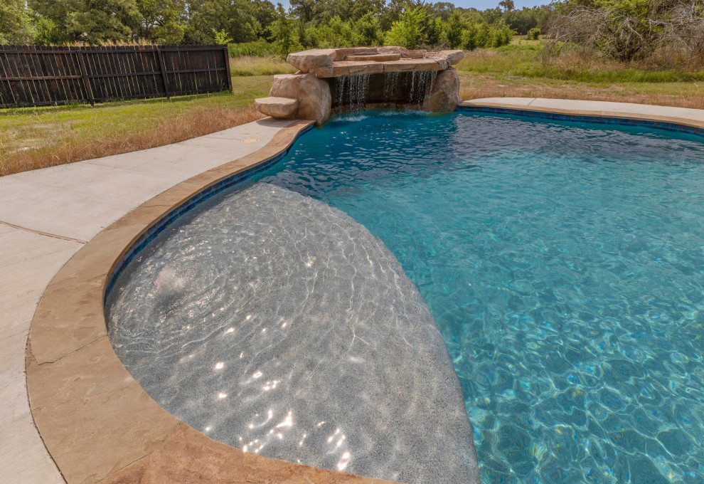 Photo of a medium sized rustic back custom shaped natural swimming pool in Other with concrete slabs.