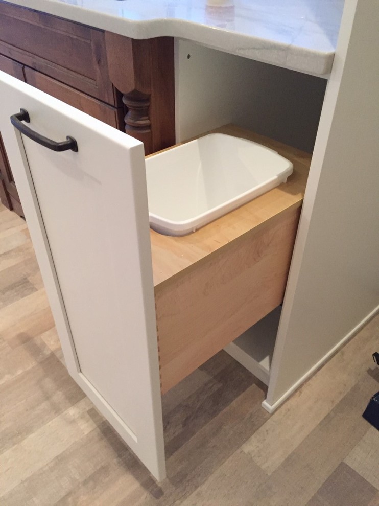 Example of a mid-sized mountain style galley medium tone wood floor and brown floor open concept kitchen design in Calgary with an undermount sink, recessed-panel cabinets, white cabinets, marble countertops, white backsplash, ceramic backsplash and a peninsula
