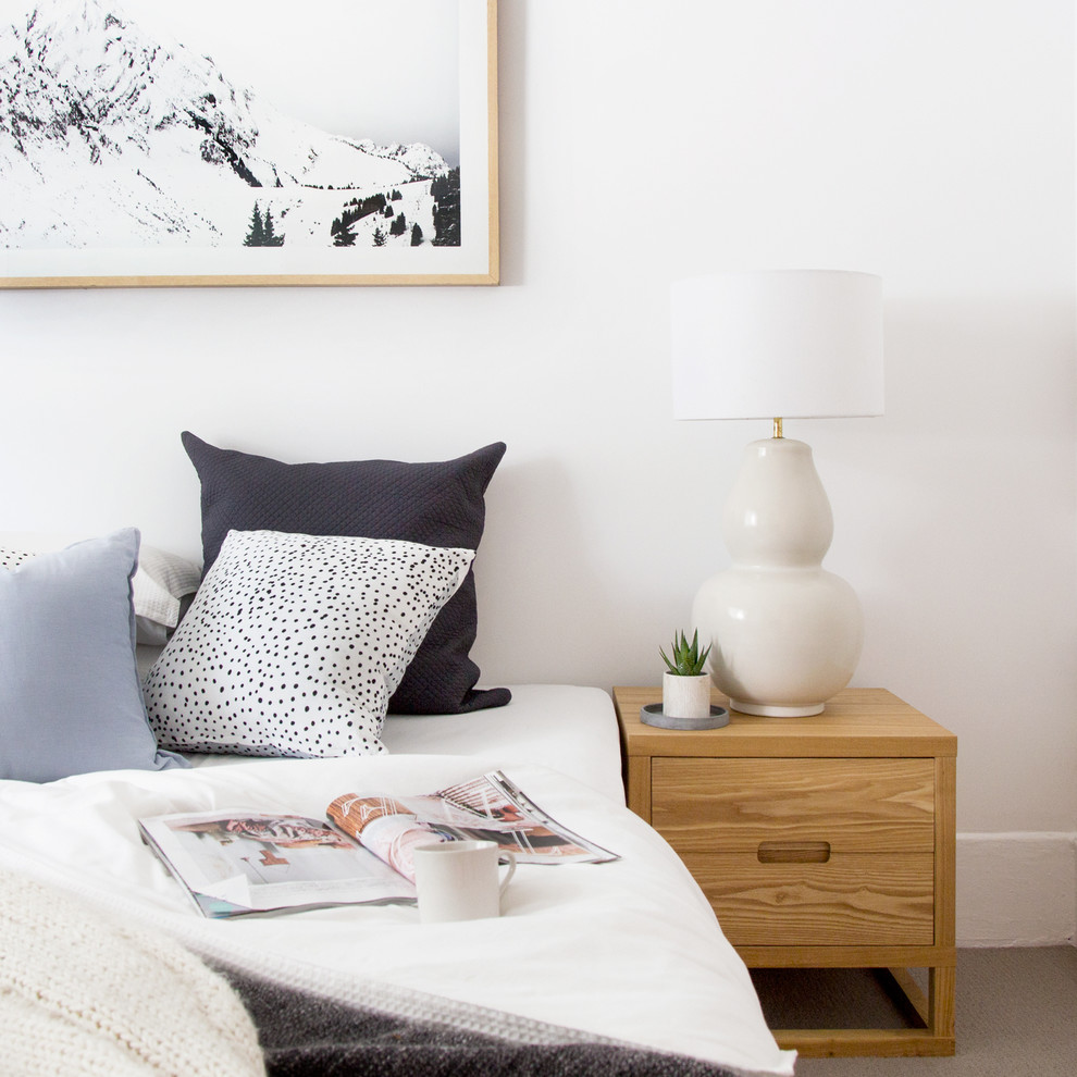 This is an example of a mid-sized scandinavian bedroom in Sydney with white walls, carpet, no fireplace and beige floor.